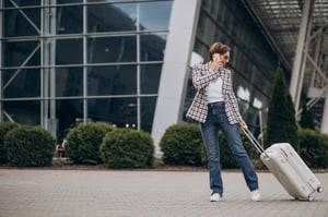 young-woman-with-luggage-airport-travelling-talking-phone